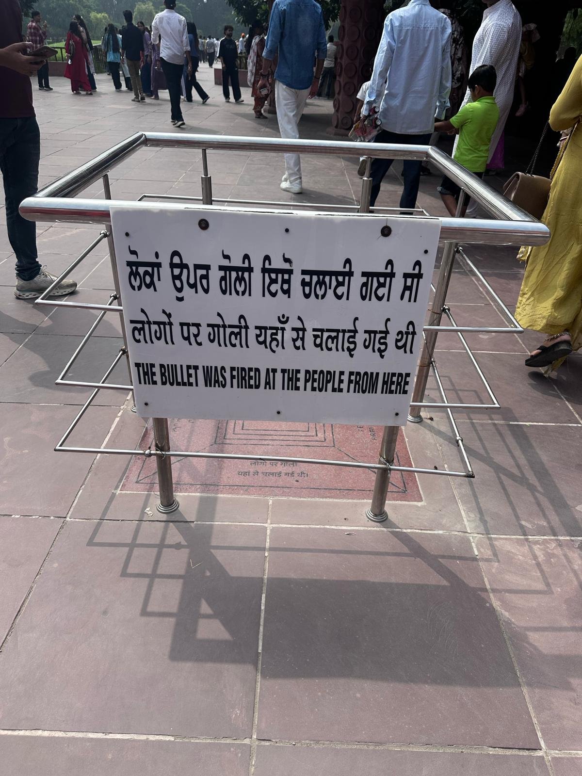 Sign at Jallianwala Bagh marking the position from which British troops fired: The Bullet Was Fired at the People from Here